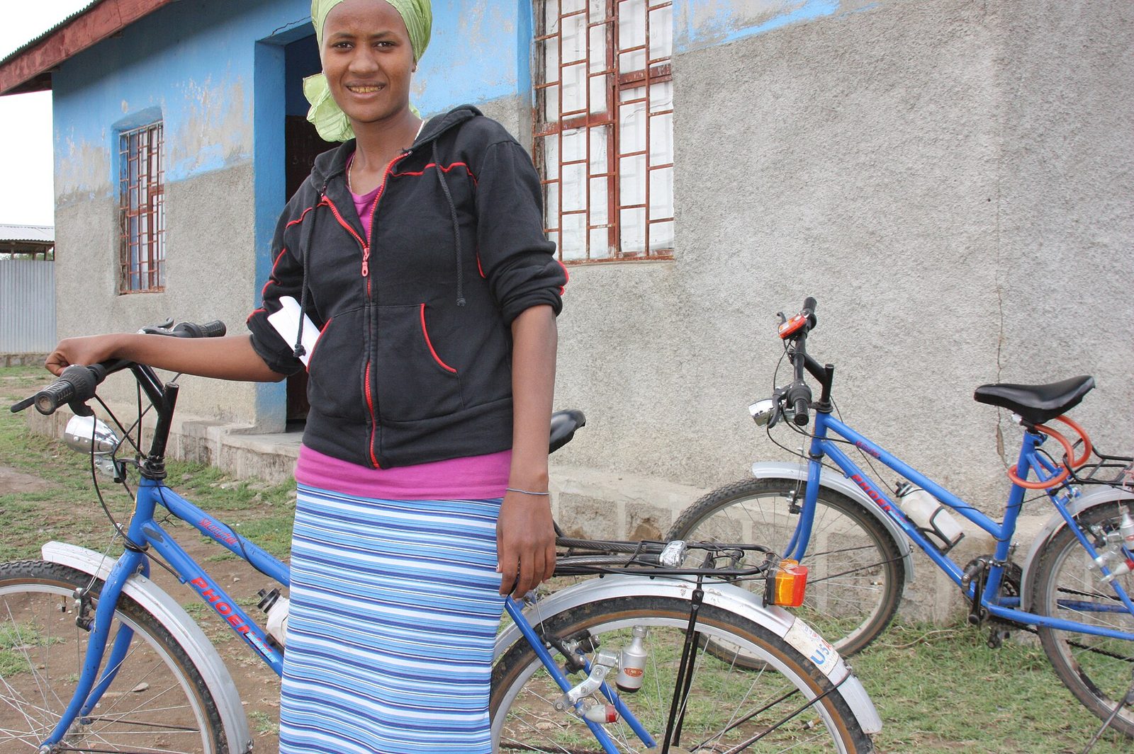 A health extension worker in Ethiopia with the bicycle she uses to reach outlying communities.